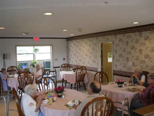 group of elderly people eating