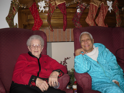 two elderly woman smiling at the camera