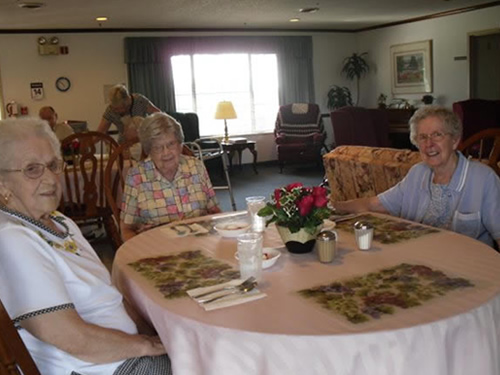 three elderly women sitting in one table