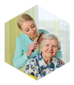 caregiver combing hair of the old woman