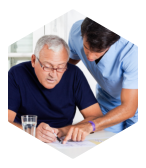 caregiver assisting old man to read