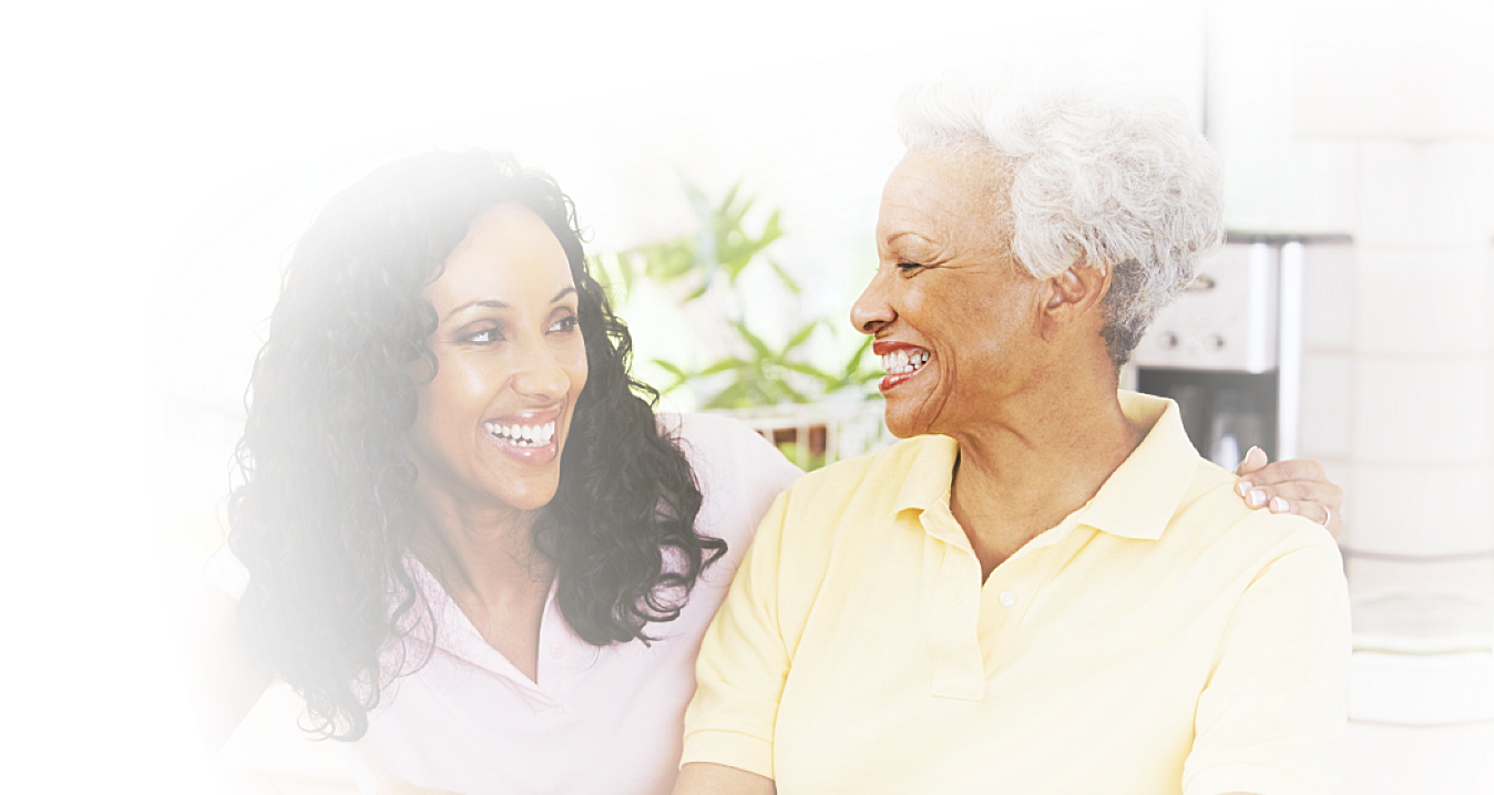 caregiver and senior woman smiling