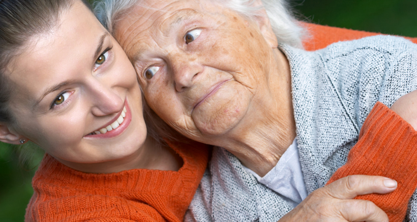 caregiver and senior woman smiling