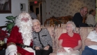 a portrait of santa claus and group of elderly people