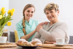 caregiver and elder smiling